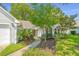 Beautiful home exterior with well-manicured landscaping and a charming walkway to the front door at 104 S Ansel Xing, Goose Creek, SC 29445
