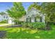 Charming home with mature landscaping and a well-maintained front yard on a sunny day at 104 S Ansel Xing, Goose Creek, SC 29445