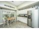 Spacious eat-in kitchen boasts stainless fridge, generous storage, and a lovely window-side dining area at 104 S Ansel Xing, Goose Creek, SC 29445