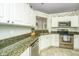 Kitchen featuring granite countertops, stainless steel appliances, white cabinetry, and open design at 104 S Ansel Xing, Goose Creek, SC 29445
