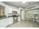 Bright eat-in kitchen features stainless appliances, granite countertops, neutral tile floors, and breakfast nook at 104 S Ansel Xing, Goose Creek, SC 29445