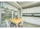 Eat-in kitchen with granite counters, white cabinets, and lots of natural light from the large window at 104 S Ansel Xing, Goose Creek, SC 29445