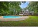 Inviting backyard with a sparkling in-ground pool, deck, and lush greenery, perfect for relaxation and outdoor entertaining at 105 Londonderry Rd, Goose Creek, SC 29445