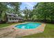 View of the backyard inground pool with home and trees in the background at 105 Londonderry Rd, Goose Creek, SC 29445