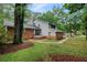 Inviting two-story home with brick and gray siding, set amidst a lush, tree-filled landscape at 105 Londonderry Rd, Goose Creek, SC 29445