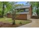 Brick house featuring a two car garage, a large driveway and a yard full of mature trees at 105 Londonderry Rd, Goose Creek, SC 29445