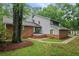 Inviting two-story home with brick and gray siding, set amidst a lush, tree-filled landscape at 105 Londonderry Rd, Goose Creek, SC 29445