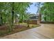 Brick house featuring a two car garage, a large driveway and a yard full of mature trees at 105 Londonderry Rd, Goose Creek, SC 29445