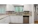 Cozy kitchen with granite counters, backsplash, and stainless steel dishwasher at 105 Londonderry Rd, Goose Creek, SC 29445