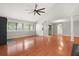Open-concept living space with hardwood floors and lots of natural light from surrounding windows at 105 Londonderry Rd, Goose Creek, SC 29445