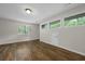 Large room with wood floors and multiple windows at 105 Londonderry Rd, Goose Creek, SC 29445