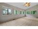 Bright sunroom with tiled flooring, lots of windows and decorative ceiling fan at 105 Londonderry Rd, Goose Creek, SC 29445