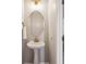 Charming powder room featuring a pedestal sink, oval mirror, and elegant gold-tone fixtures at 1054 Bennington Dr, Charleston, SC 29492