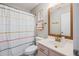 Well-lit bathroom with vanity, mirror, cabinet, shower with striped curtain and modern fixtures at 1054 Bennington Dr, Charleston, SC 29492