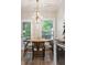 Cozy dining area with a modern chandelier and backyard view at 1054 Bennington Dr, Charleston, SC 29492