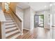 Inviting foyer with wood floors, staircase, and entry door leading to the outside at 1054 Bennington Dr, Charleston, SC 29492