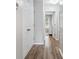 Hallway features wood floors, white doors, and natural light filtering into the home at 1054 Bennington Dr, Charleston, SC 29492