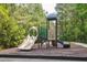 Playground area with slide and green accents in a wooded setting at 1054 Bennington Dr, Charleston, SC 29492