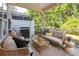 Comfortable screened porch with seating, string lights, and views of the surrounding greenery at 1054 Bennington Dr, Charleston, SC 29492