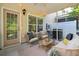 Relaxing screened porch with comfortable seating, string lights, and outdoor views of the yard at 1054 Bennington Dr, Charleston, SC 29492