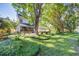Expansive backyard with a covered porch, patio, deck, mature trees, and lush lawn is perfect for entertaining at 1081 Groves Manor Ct, Mount Pleasant, SC 29464