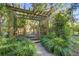 Charming backyard wooden pergola surrounded by mature landscaping at 1081 Groves Manor Ct, Mount Pleasant, SC 29464