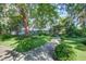 Manicured backyard with mature landscaping and a pergola at 1081 Groves Manor Ct, Mount Pleasant, SC 29464