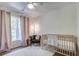 Cozy Bedroom with a crib, accent chair, and soft lighting creating a comforting space for a baby at 1081 Groves Manor Ct, Mount Pleasant, SC 29464