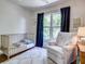 Welcoming Bedroom featuring a comfortable chair, plush rug, and a crib with soft blue accents at 1081 Groves Manor Ct, Mount Pleasant, SC 29464