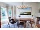 Elegant dining room with modern chandelier, sleek wooden table, and natural light from large windows at 1081 Groves Manor Ct, Mount Pleasant, SC 29464