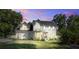 Lovely home at dusk featuring a well-kept lawn, traditional design, and inviting curb appeal at 1081 Groves Manor Ct, Mount Pleasant, SC 29464
