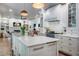 Bright kitchen boasts a marble island, custom cabinets, and stainless steel appliances at 1081 Groves Manor Ct, Mount Pleasant, SC 29464