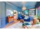 Cozy living room boasts stylish blue decor, a comfortable sofa, and built-in bookshelves filled with decor at 1081 Groves Manor Ct, Mount Pleasant, SC 29464