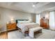 Bright main bedroom with a tray ceiling, ceiling fan, and stylish furnishings for a relaxing retreat at 1081 Groves Manor Ct, Mount Pleasant, SC 29464