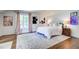 Light-filled primary bedroom boasts a bed, stylish rug, and tasteful decor at 1081 Groves Manor Ct, Mount Pleasant, SC 29464