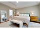 Spacious main bedroom with large bed, sitting bench, and ample natural light creates an inviting atmosphere at 1081 Groves Manor Ct, Mount Pleasant, SC 29464