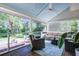 Relaxing screened porch with comfortable seating and views of the lush backyard at 1081 Groves Manor Ct, Mount Pleasant, SC 29464