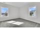 Bedroom with neutral walls, gray carpet, and two windows offering water views and natural light at 1095 Saltwater Cir, Johns Island, SC 29455