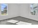 Bedroom featuring two windows with natural light and gray carpet at 1095 Saltwater Cir, Johns Island, SC 29455