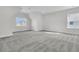 Spacious bedroom with large windows for ample natural light, complemented by neutral carpet at 1095 Saltwater Cir, Johns Island, SC 29455