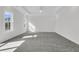 Spacious, naturally lit bedroom with neutral walls, gray carpet, and recessed lighting at 1095 Saltwater Cir, Johns Island, SC 29455
