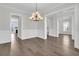 Spacious dining room with hardwood floors, wainscoting, and modern lighting fixture at 1095 Saltwater Cir, Johns Island, SC 29455