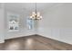 Bright dining room with hardwood floors, white wainscoting, and natural light from the large windows at 1095 Saltwater Cir, Johns Island, SC 29455