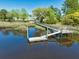 Aerial view of dock with marsh views, serene water reflection, and lush landscape at 1095 Saltwater Cir, Johns Island, SC 29455