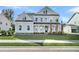 Beautiful light blue two-story home boasts a manicured lawn and charming curb appeal at 1095 Saltwater Cir, Johns Island, SC 29455