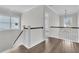 Hallway with dark hardwood floors, white banisters, and natural light shining through windows at 1095 Saltwater Cir, Johns Island, SC 29455