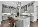 The stylish gray kitchen has an island with barstool seating and modern lighting at 1095 Saltwater Cir, Johns Island, SC 29455
