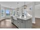 Bright kitchen island with a farmhouse sink, hardwood flooring, and pendant lighting at 1095 Saltwater Cir, Johns Island, SC 29455