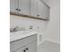 Laundry room features gray cabinets with white countertops, utility sink, and marble floors at 1095 Saltwater Cir, Johns Island, SC 29455