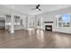 Bright living room boasts a fireplace, hardwood flooring, and an open transition to the kitchen at 1095 Saltwater Cir, Johns Island, SC 29455